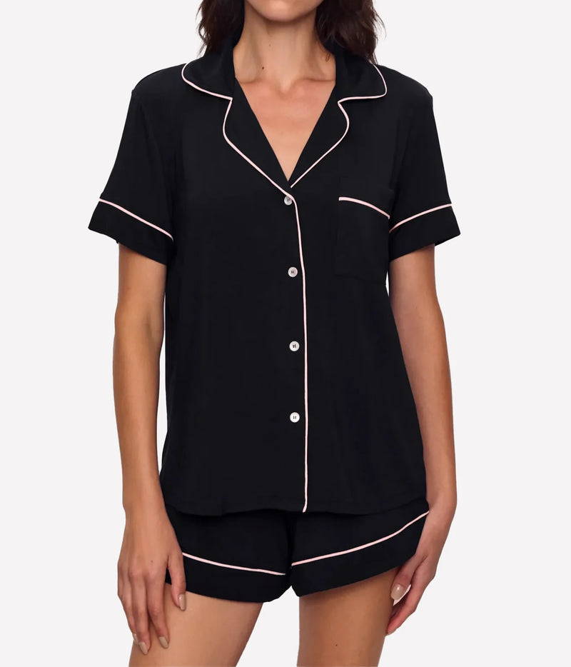 Model wearing the Eberjey Gisele Relaxed Short PJ Set In Black Sorbet Pink, front view showing the short sleeve button-up top with notch collar, chest pocket and sorbet pink piping, with matching shorts