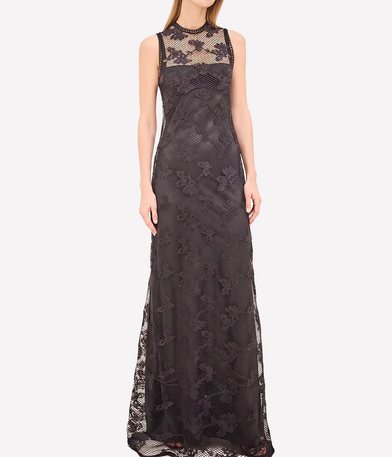 A sleeveless black lace maxi dress with a sheer mesh high neck and floral lace applique, shown on a model against a light gray background.