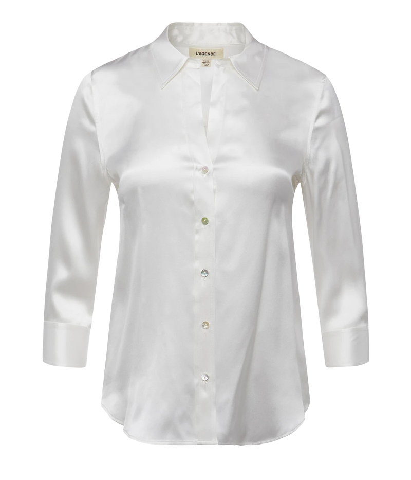 A soft ivory charmeuse silk button-down blouse with a relaxed open collar, three-quarter-length sleeves, and a curved hem. 