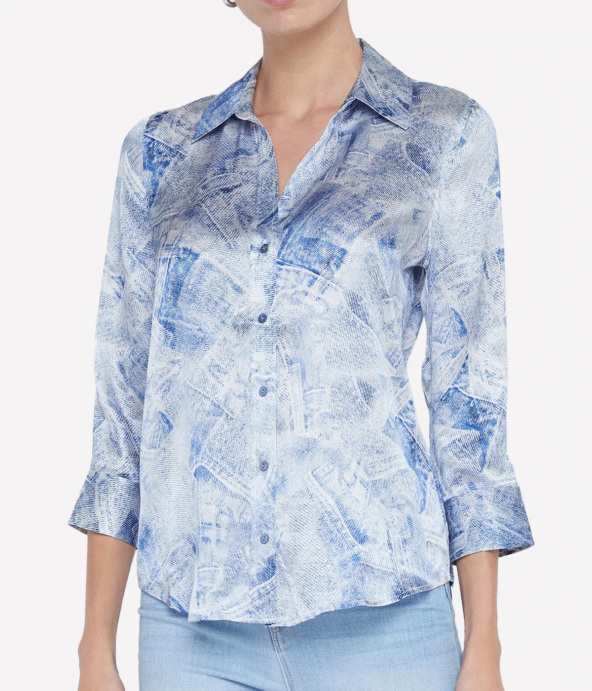 Elegant silk button-down blouse with a high-low hem, styled for a chic and versatile look.