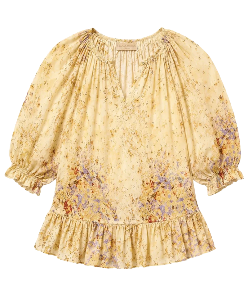 A women's blouse with a yellow-beige base, featuring a delicate multicolor floral print and voluminous puff sleeves with ruffled cuffs and a ruffled hem.