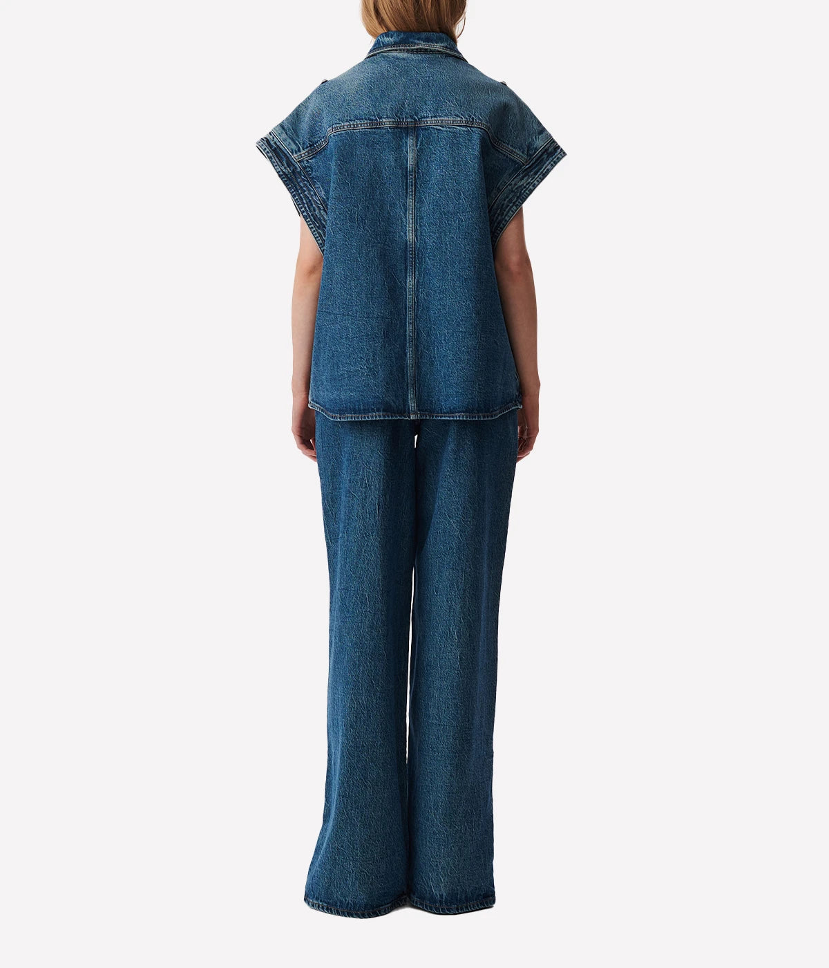 Elycia Denim Shirt in Denim Blue by IRO, sleeveless with a collar, breast pockets, and metal pop buttons, offering a relaxed fit in classic denim blue.