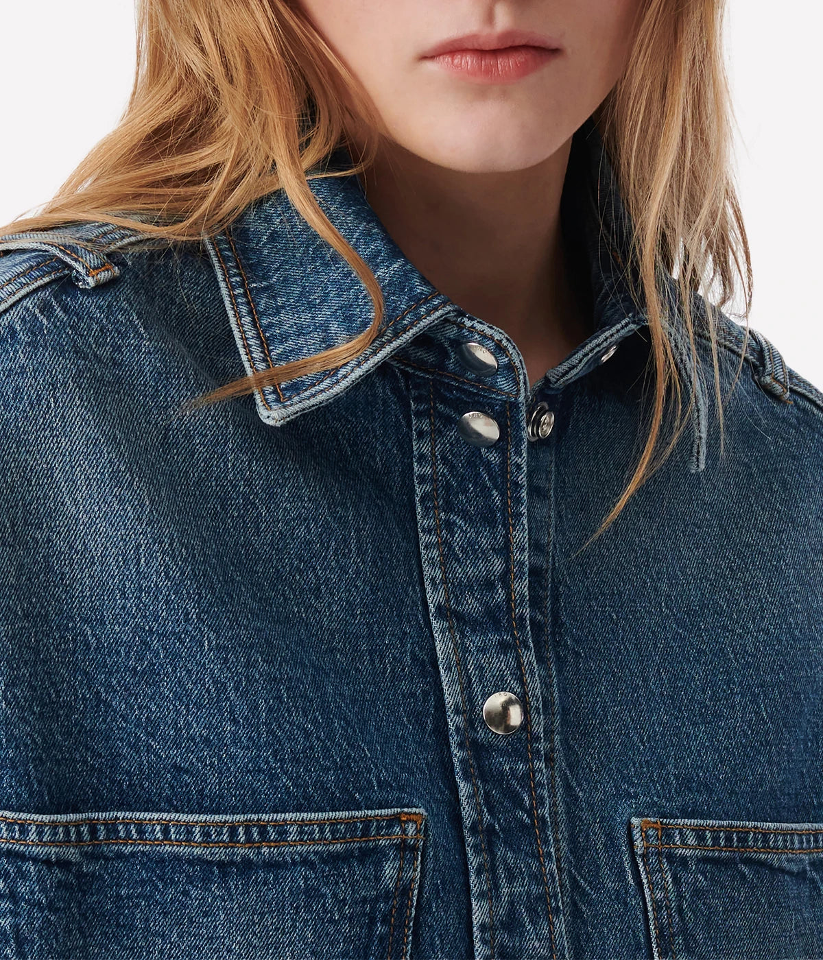 Elycia Denim Shirt in Denim Blue by IRO, sleeveless with a collar, breast pockets, and metal pop buttons, offering a relaxed fit in classic denim blue.