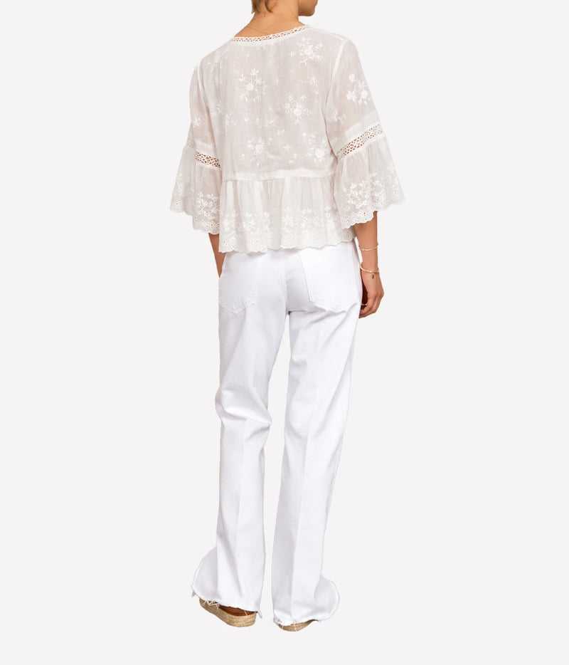 Back view of the M.A.B.E Sisi embroidered top in Ivory, worn with white jeans.