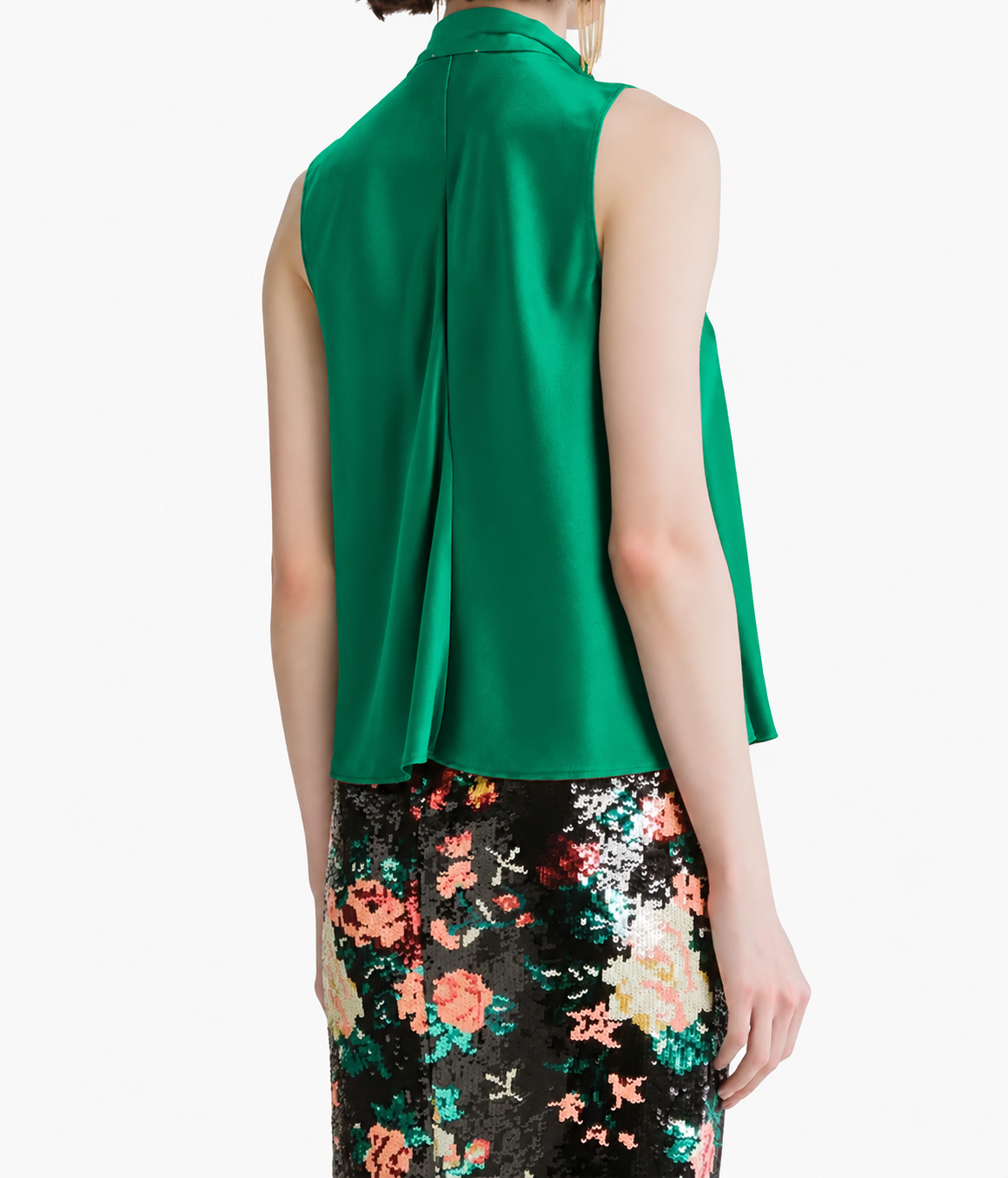 Angled back view of the Forte Forte silk satin sash top in Royal, showing the inverted back pleat, worn with a floral sequin skirt.