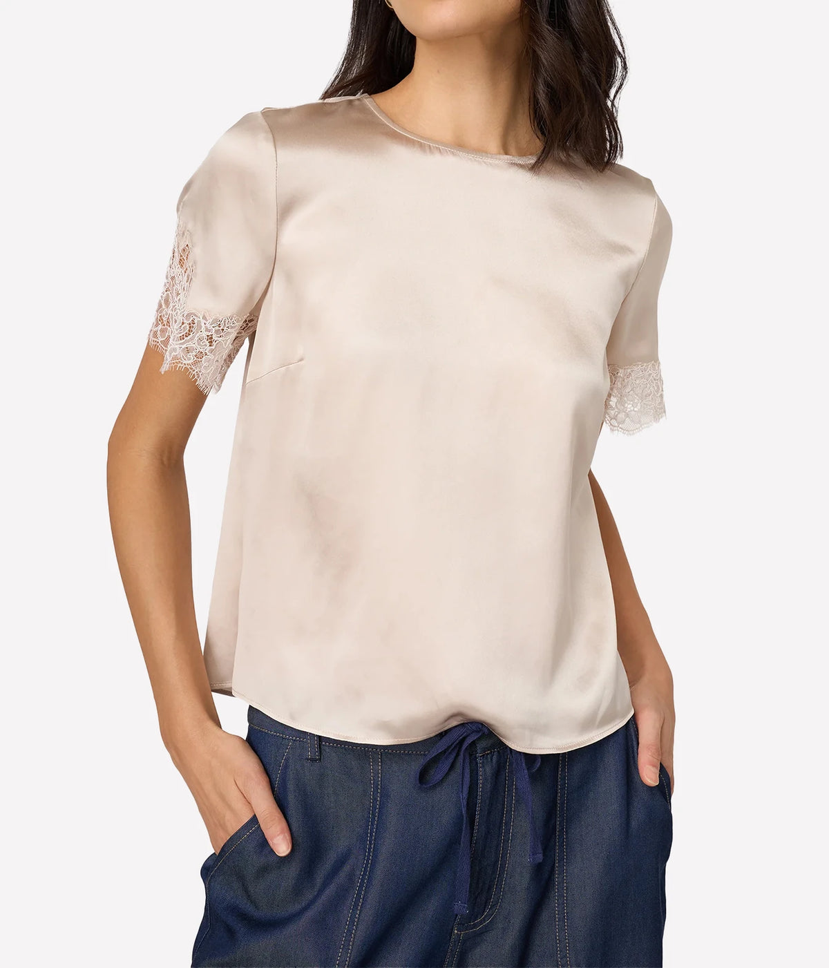 Model wearing Cami NYC Marguerite Silk Top in Oat with dark denim