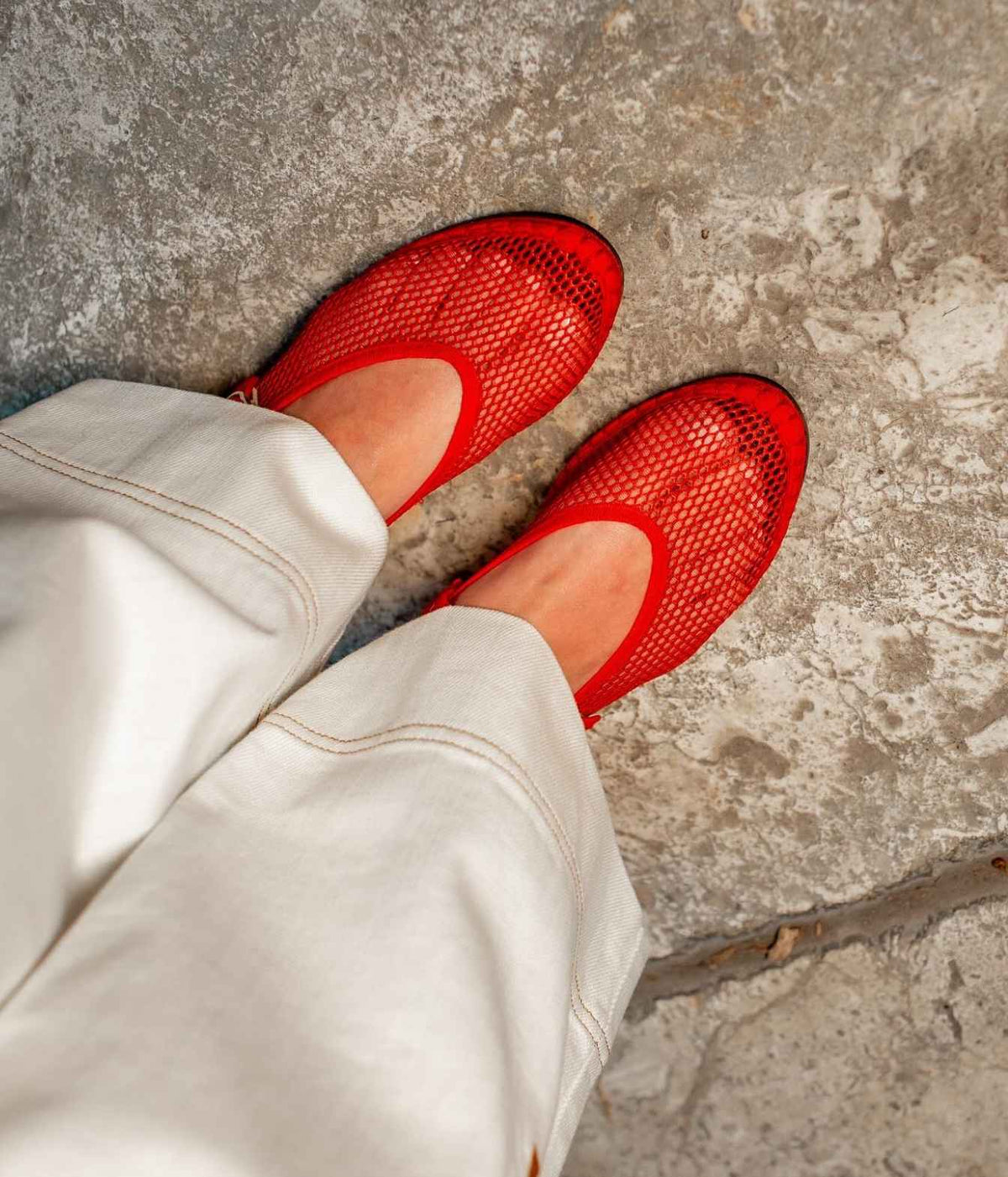 Model wearing the Flabelus Isabella in Red with cream wide-leg trousers