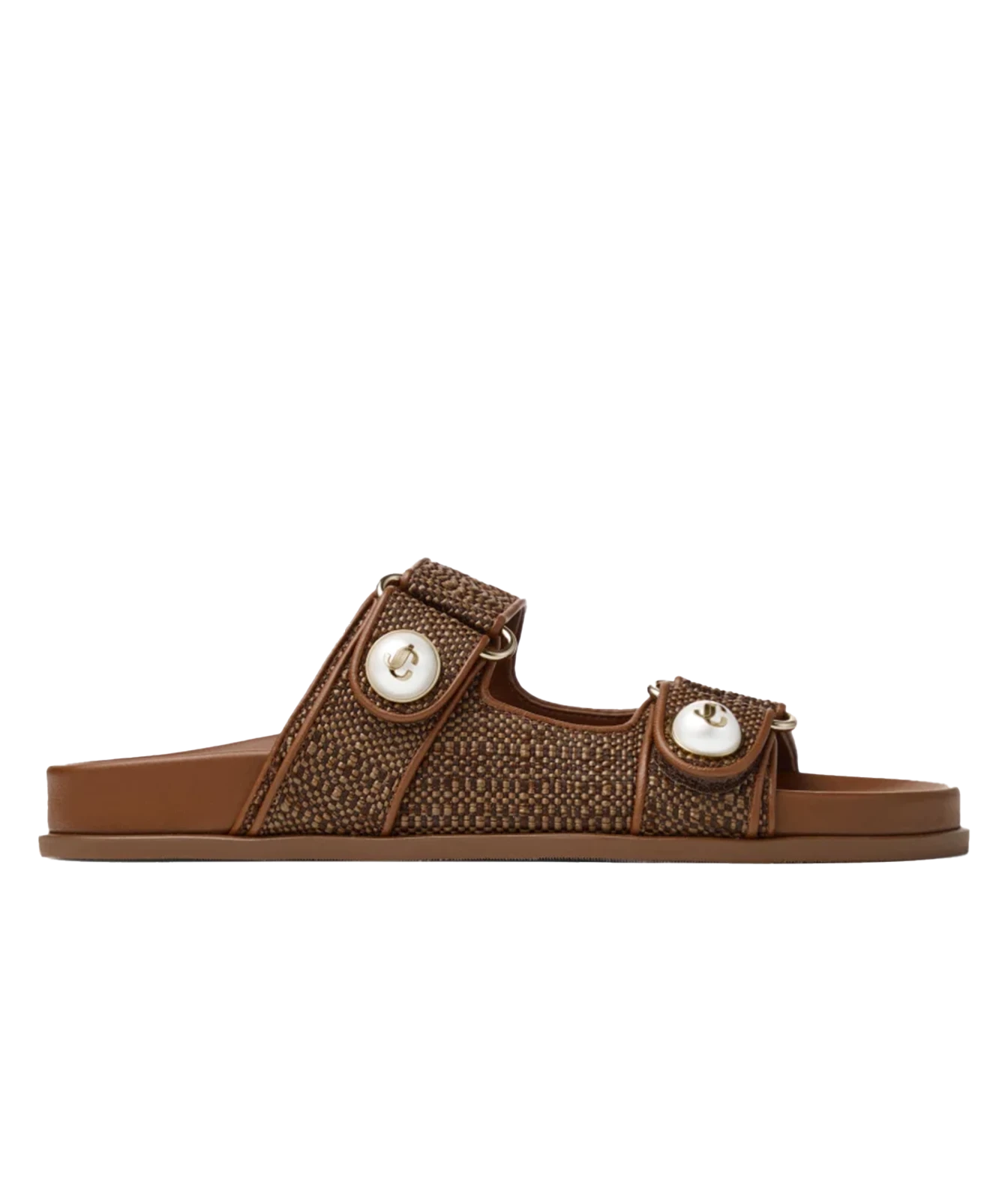A single brown slide sandal with a woven patterned strap, two adjustable straps with white circular accents, and a flat sole, shown against a plain white background.