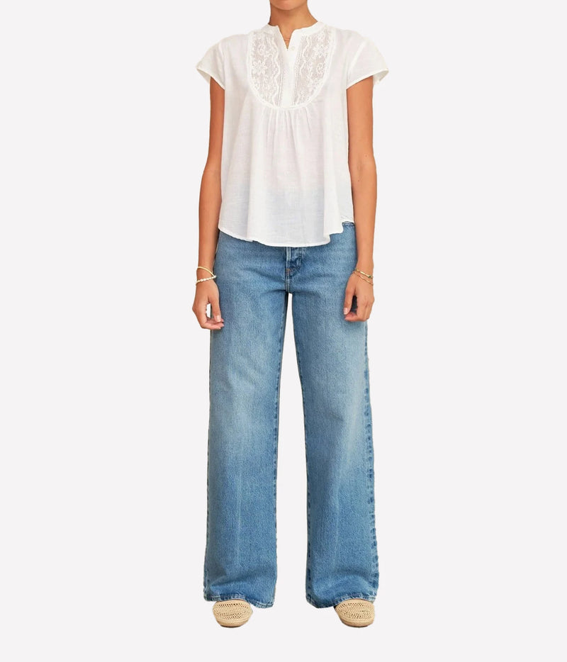 Model wearing the M.A.B.E Freya Short Sleeve Top in White with denim – front view