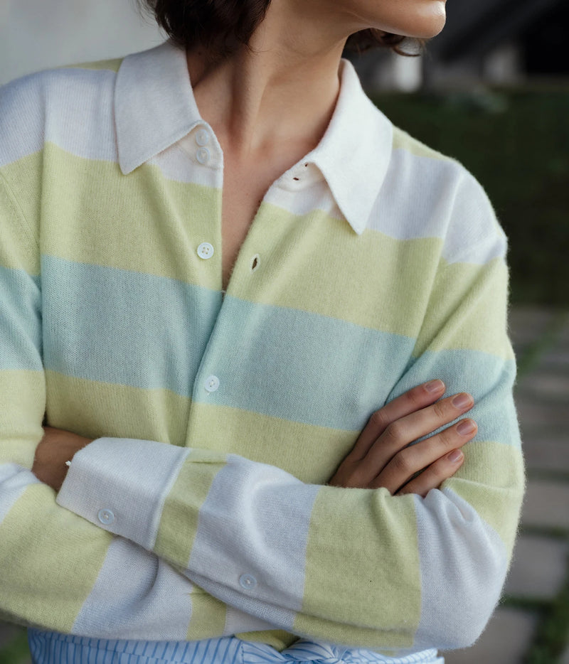 Model wearing the CISSA Rugby Cardigan in Sorbet Swirl with arms crossed, showing the long sleeves and white collar