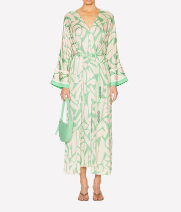 Loose fitting, lightweight long loose sleeve viscose dress. Features a green and cream abstract print with a beaded tie waist . Bra-friendly V neck line. 