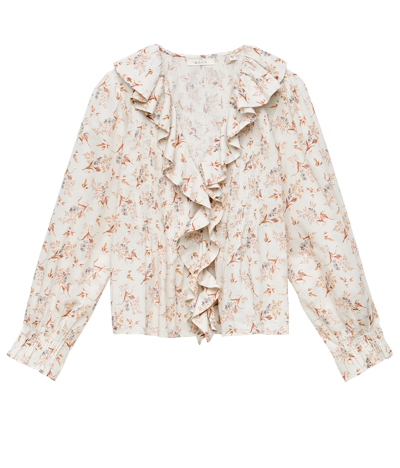 A long-sleeve blouse with a cream base and a delicate orange-brown floral print, featuring prominent ruffles along the front neckline and a ruffled hemline.