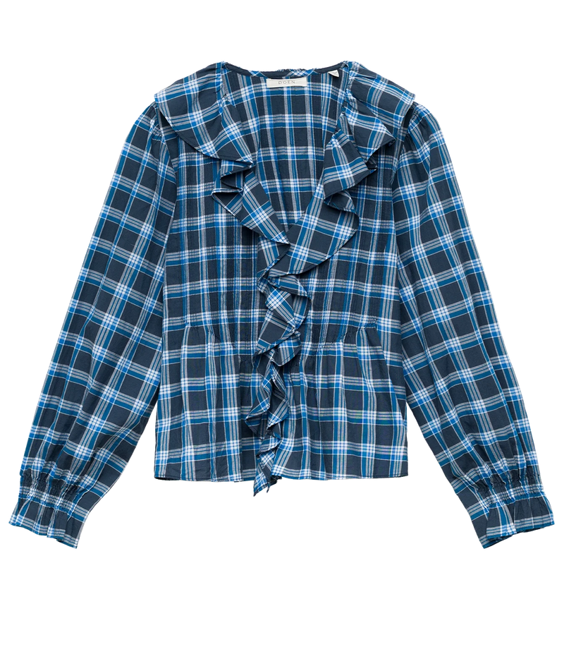 A long-sleeve plaid blouse with a ruffled front detail, featuring a blue, navy, and white tartan pattern, laid flat against a white background.
