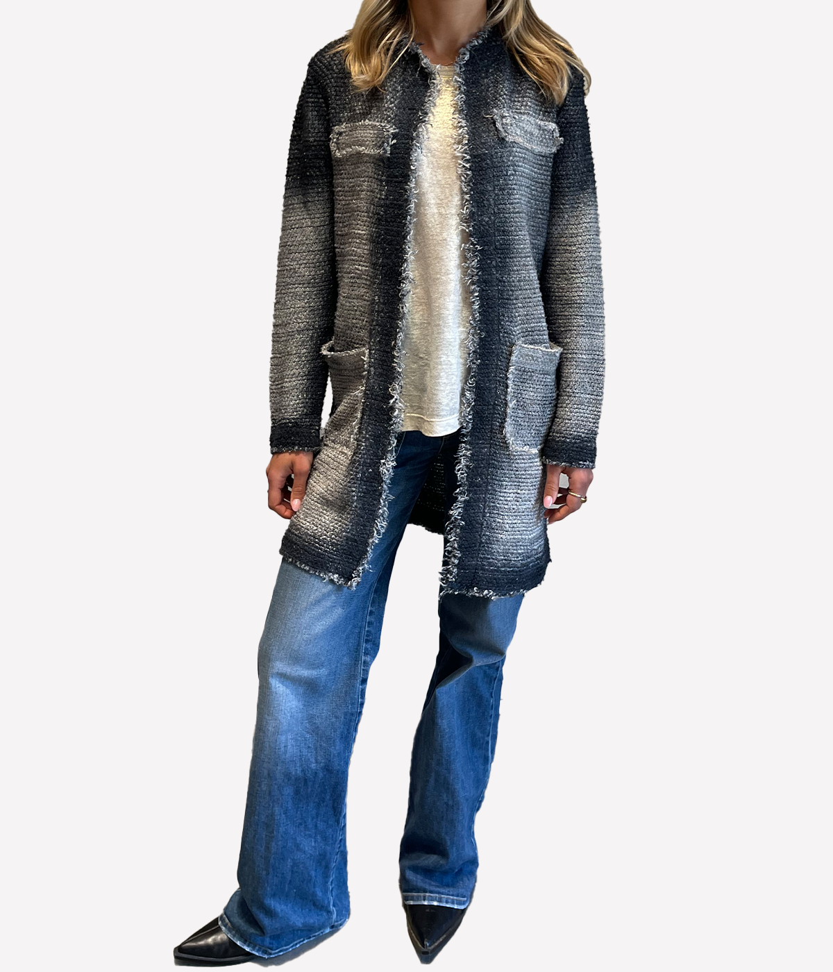 ALT text: Model wears long hand-painted stitch jacket in grey ‘Huskey’ tone with contrast stitching and open front design