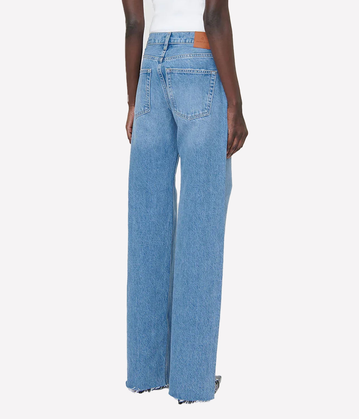 The Hugh Jean is a relaxed, '90s-inspired jean crafted from a midweight, rigid organic-cotton blend. With no stretch, these jeans feature a classic blue wash, enhanced by vintage-inspired grinding, hand sanding, and subtle highs and lows throughout for an authentic, lived-in look. The wide, full-length leg and raw-edge hem add to the timeless appeal, making these jeans a perfect blend of comfort and style. Made in Turkey for premium quality and craftsmanship.
