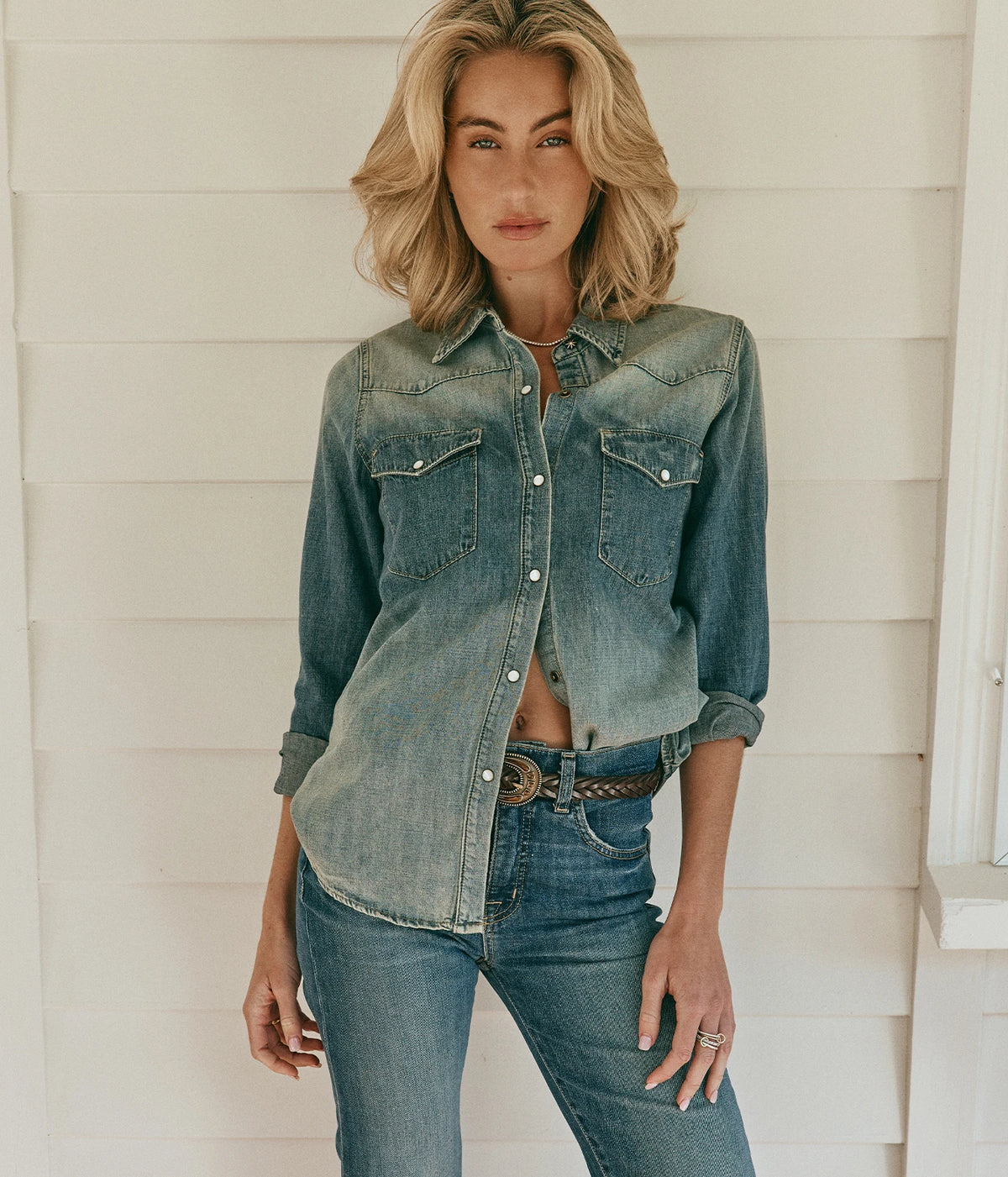 Nili Lotan Travis Shirt In Classic Wash, front view on model tucked into blue jeans with a brown belt