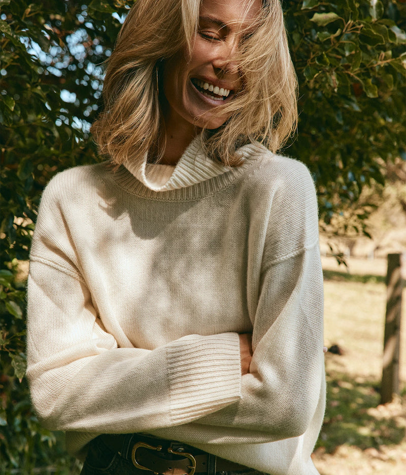 Soft Goat Alpaca Boyfriend Turtleneck in Feather White – Front View with model crossing her arms