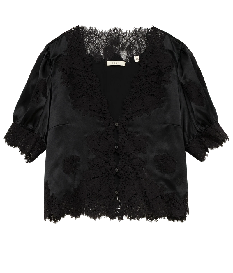 DÔEN Idella Top In Black laid flat, showing the black satin short puff sleeves, scalloped lace trim and button-front placket