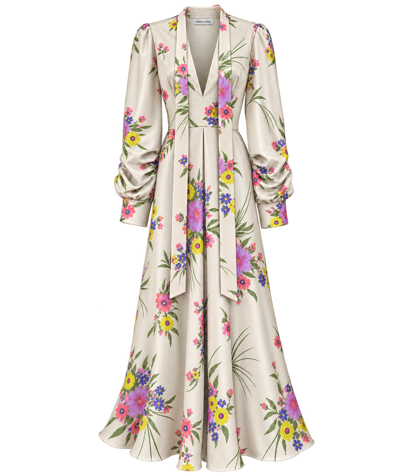 Raquel Diniz Valerie Dress in Pink Floral laid flat, showing the ivory silk with pink, purple and yellow florals, plunging V-neckline, long neck ties, gathered long sleeves and flared maxi skirt