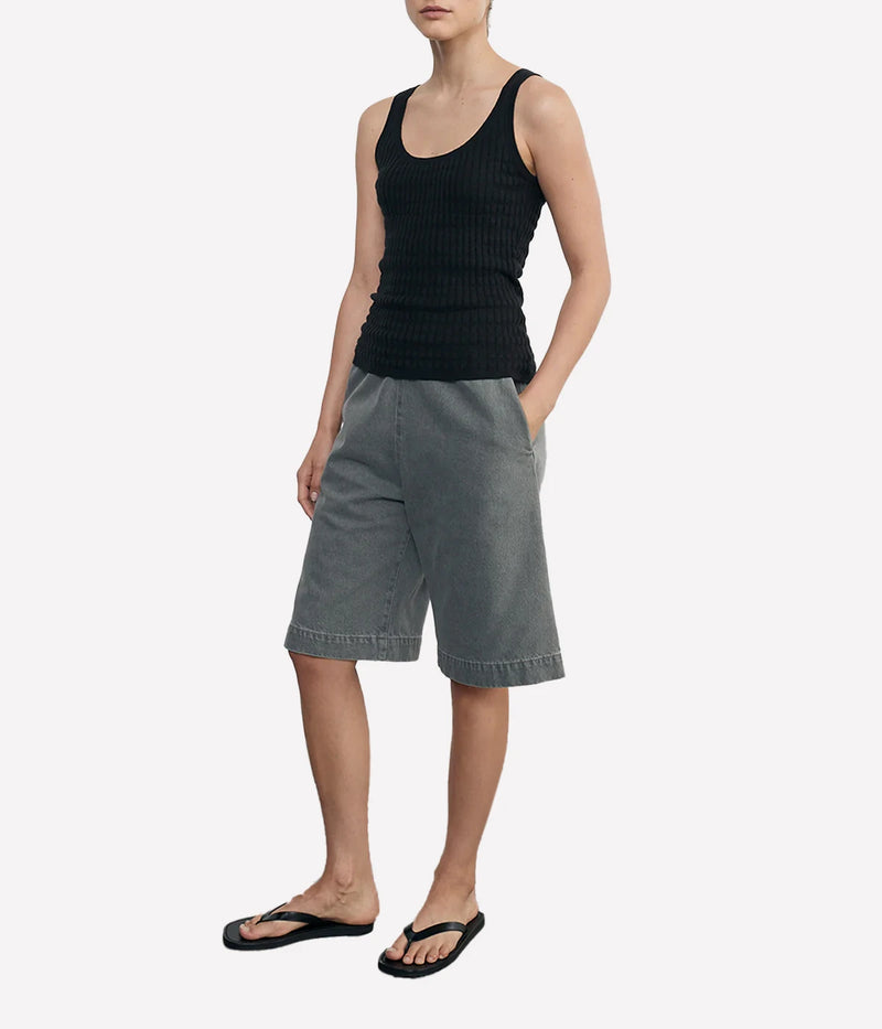 Lightweight sweater-knit tank with a scoop neckline and delicate pointelle stitch, made from a breathable linen-cotton blend.
