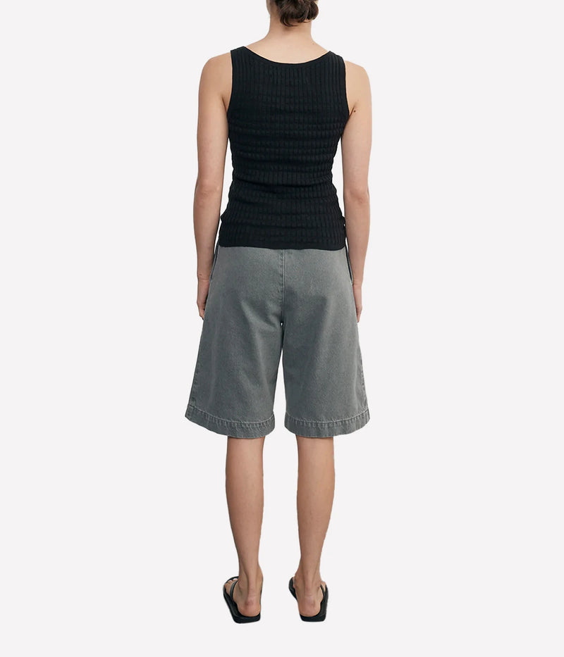 Lightweight sweater-knit tank with a scoop neckline and delicate pointelle stitch, made from a breathable linen-cotton blend.