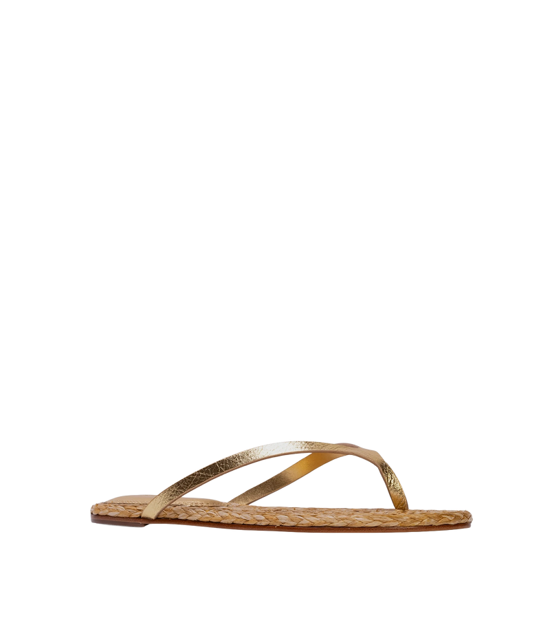 A single flat thong sandal shown in side profile, features a textured woven natural-fiber footbed in a light tan color and metallic gold straps - Alaya Sandal in Gold Metallic