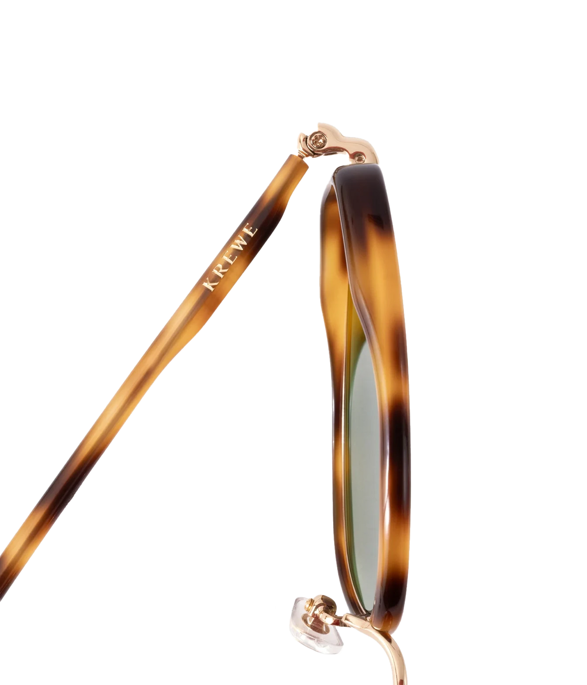 Close-up of the KREWE Leah Sunglasses in 18K Maple, showing the tortoise acetate temple arm and gold hinge