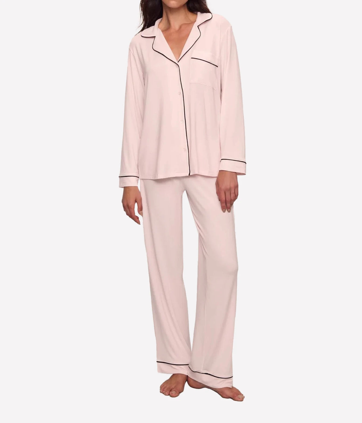 Full-length front view of a model wearing the Eberjey Gisele Long Sleeve PJ Set in Sorbet Pink & Black, showing the button-up top with black piping on the collar, pocket and cuffs, with matching full-length pants
