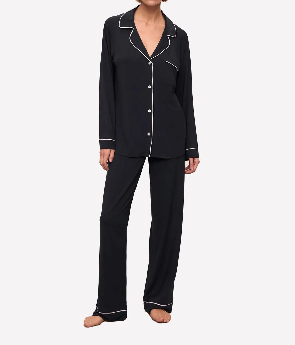 Full-length front view of a model wearing the Eberjey Gisele Long Sleeve PJ Set in Black & Sorbet Pink, showing the button-up top with notch collar, chest pocket and sorbet pink piping, with matching full-length pants
