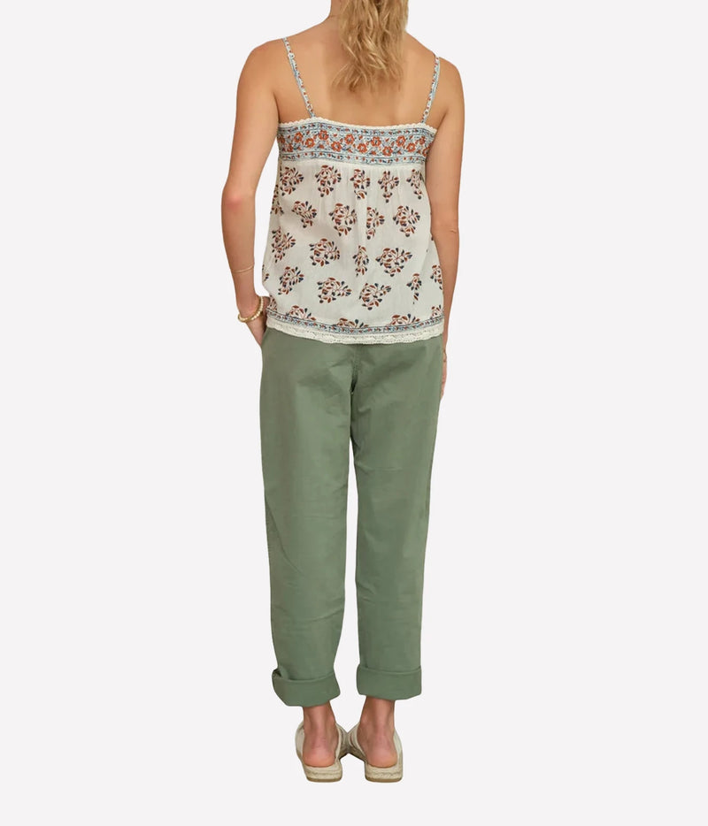 Rear view of the M.A.B.E Stella print cami in Ecru & Rust, worn with green trousers.