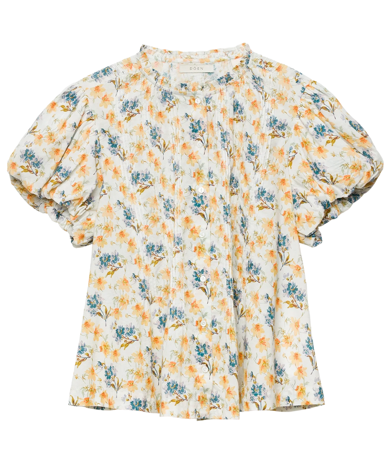 A short-sleeve blouse with a white base and an all-over floral print in orange and blue, featuring puffed short sleeves and a button-down front.