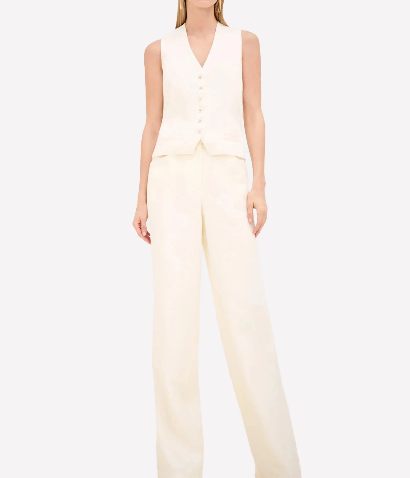 A model wearing a cream-colored sleeveless vest and matching wide-leg trousers against a plain white background.