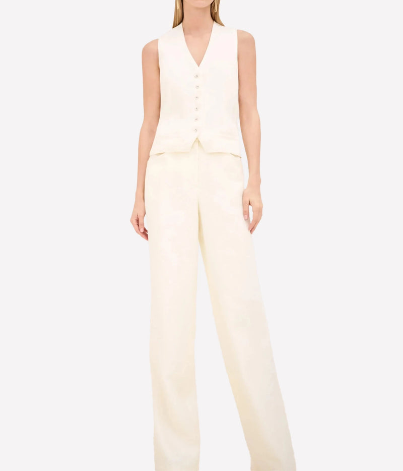 A model wearing a cream-colored sleeveless vest and matching wide-leg trousers against a plain white background.