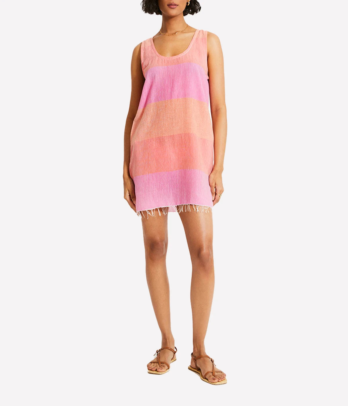 A relaxed tank dress featuring an ombre colour block in pink, blush, and peach, with a scoop neckline and fringe hem detail.