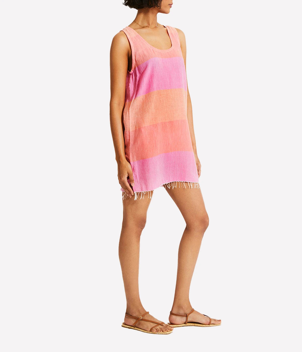 A relaxed tank dress featuring an ombre colour block in pink, blush, and peach, with a scoop neckline and fringe hem detail.