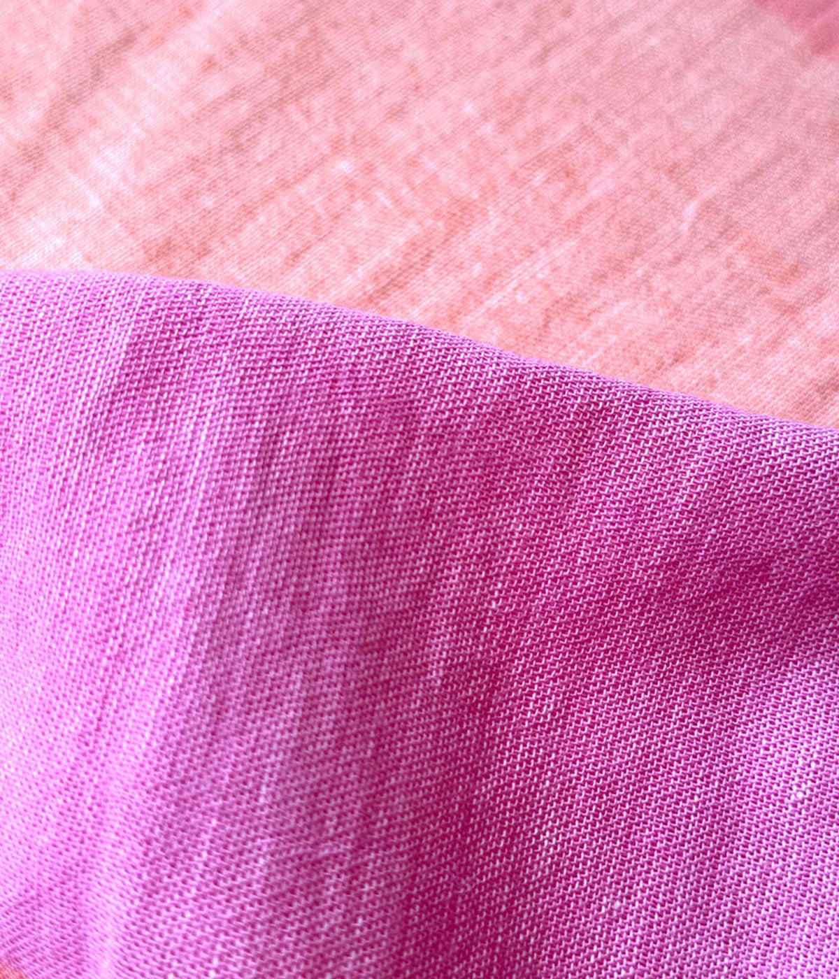 A relaxed tank dress featuring an ombre colour block in pink, blush, and peach, with a scoop neckline and fringe hem detail.
