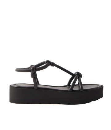 Black slip-on leather sandals. Easy to wear summer shoe, pair with your favourite summer outfit. Knotten details atop a thick rubber platform. All day comfort, perfect for walking.  