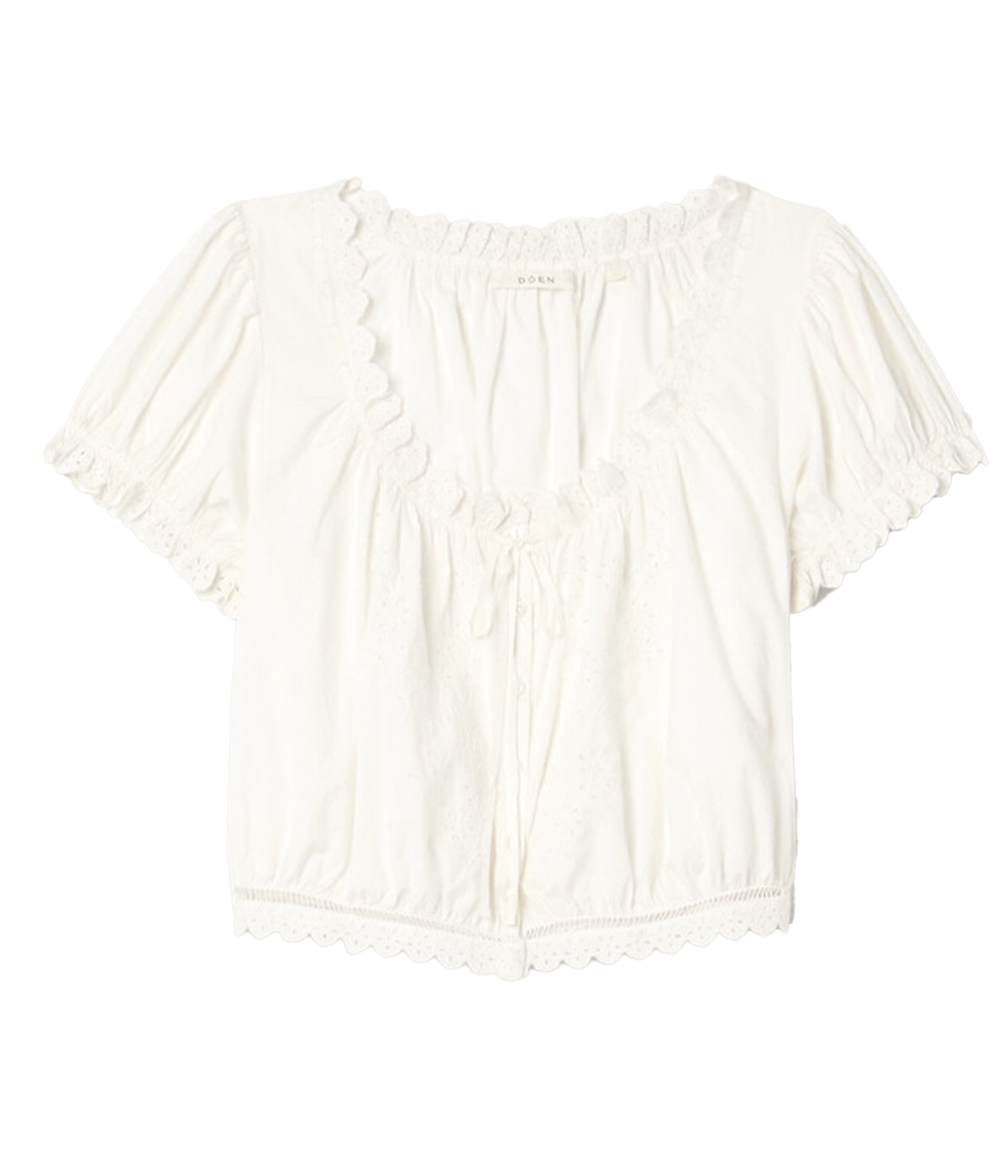 ALT text: Nera Top in white organic cotton poplin with puffed sleeves, floral eyelet details, and a grosgrain ribbon tie at the neckline.