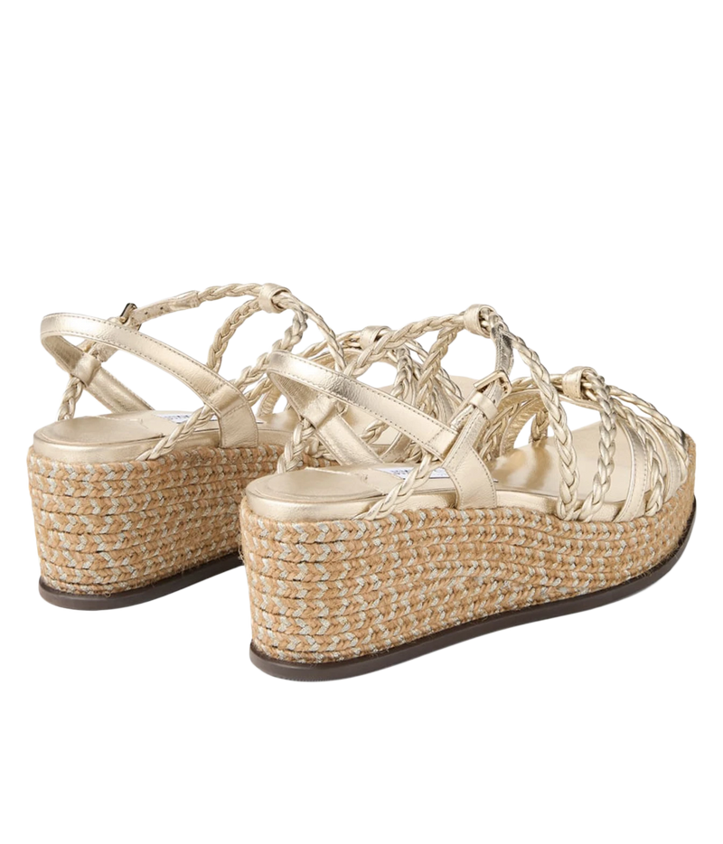 A pair of women's platform wedge sandals featuring metallic champagne-gold woven straps and a natural jute-wrapped wedge heel, shown against a plain white background.