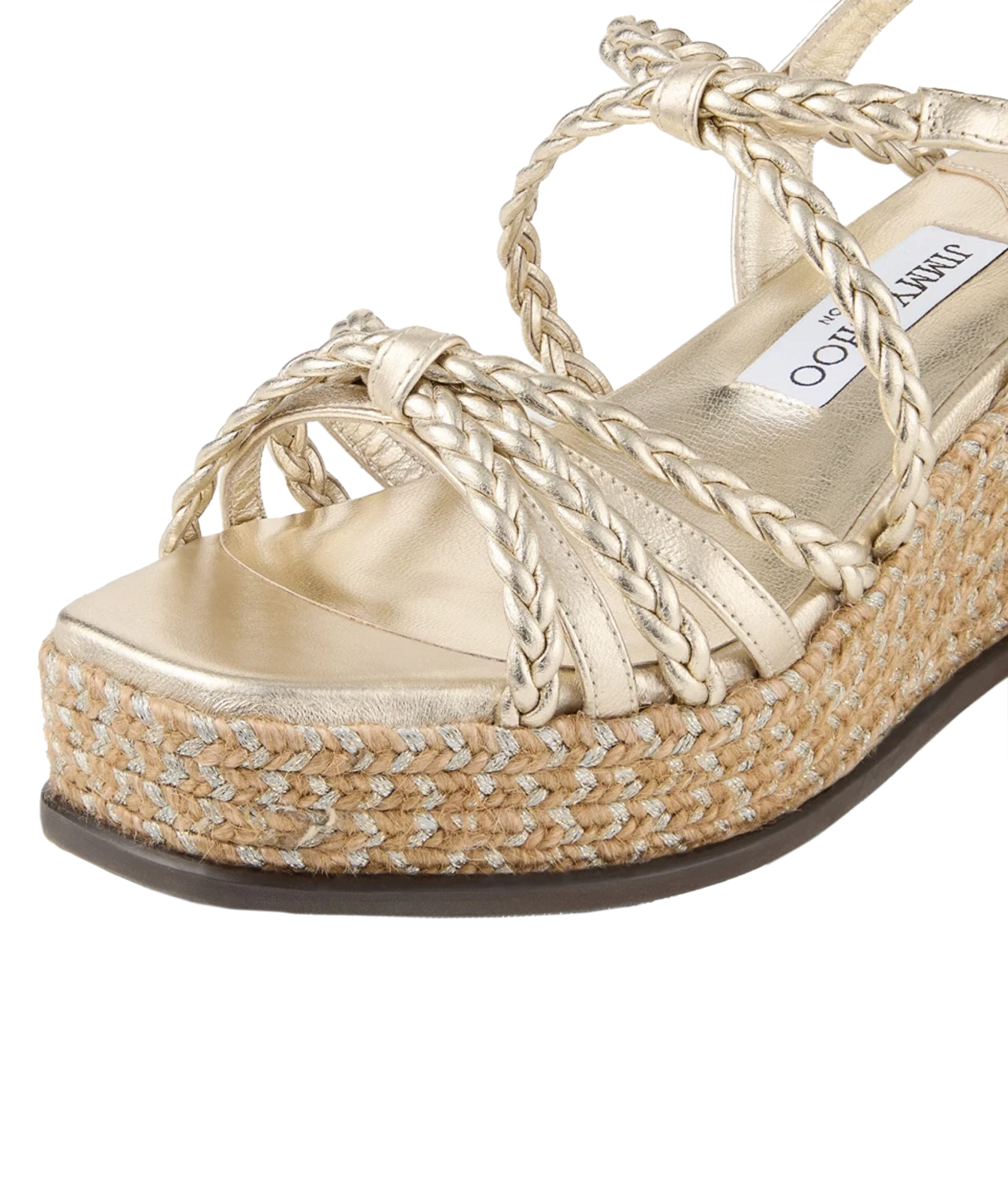 A close-up of a metallic gold platform espadrille sandal with braided straps and a woven jute platform sole, featuring a visible Jimmy Choo insole label.