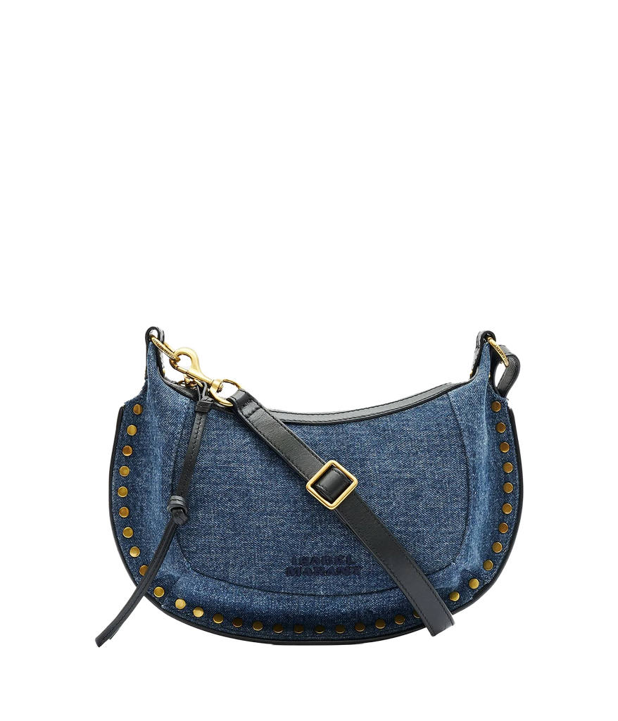 Isabel Marant’s iconic Oskan Moon Bag in a new denim look. Crafted from 100% cotton with leather details, wear this compact purse over your shoulder, cross body or carry by hand for an easy everyday look. 