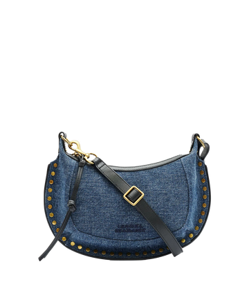 Isabel Marant’s iconic Oskan Moon Bag in a new denim look. Crafted from 100% cotton with leather details, wear this compact purse over your shoulder, cross body or carry by hand for an easy everyday look. 