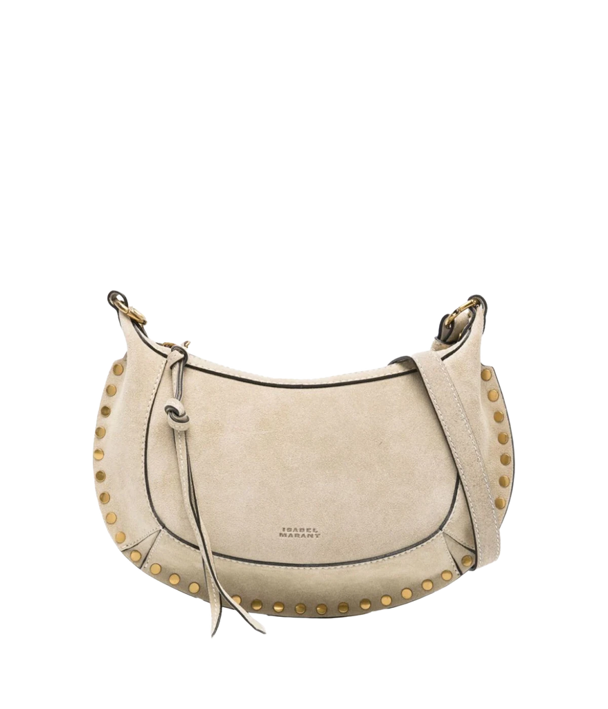 Isabel Marant’s iconic Oskan Moon Bag in an elegant sand suede leather shade. Wear this compact gold studded purse over your shoulder, cross body or carry by hand for an easy everyday look. 