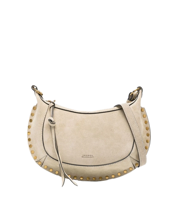 Isabel Marant’s iconic Oskan Moon Bag in an elegant sand suede leather shade. Wear this compact gold studded purse over your shoulder, cross body or carry by hand for an easy everyday look. 