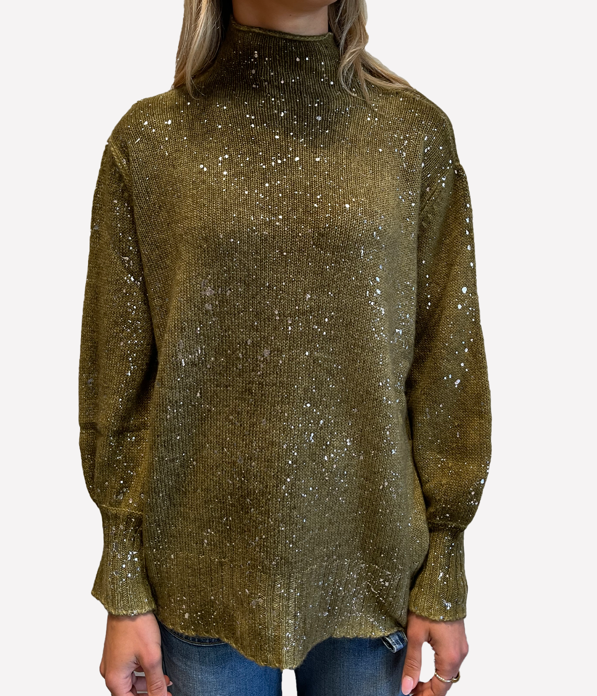 ALT text: Model wears olive green oversized pullover with laminated finish, off-gauge knit and voluminous sleeves