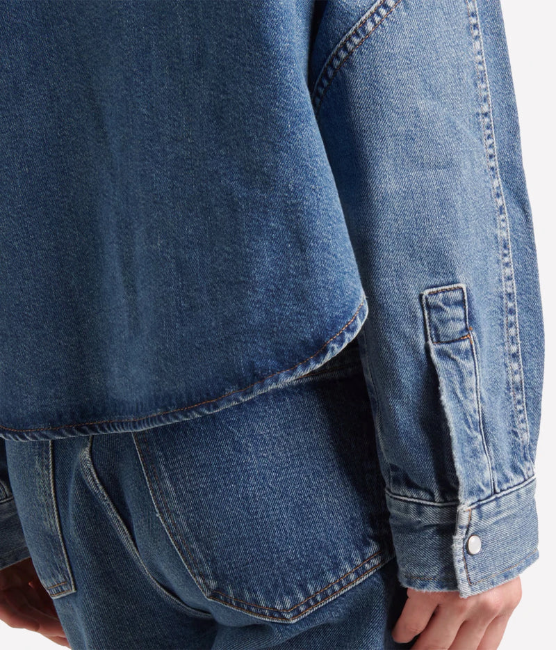 Detail of the Citizens Of Humanity Cropped Western Shirt in Chaya showing the curved back hem, sleeve placket and snap-button cuff