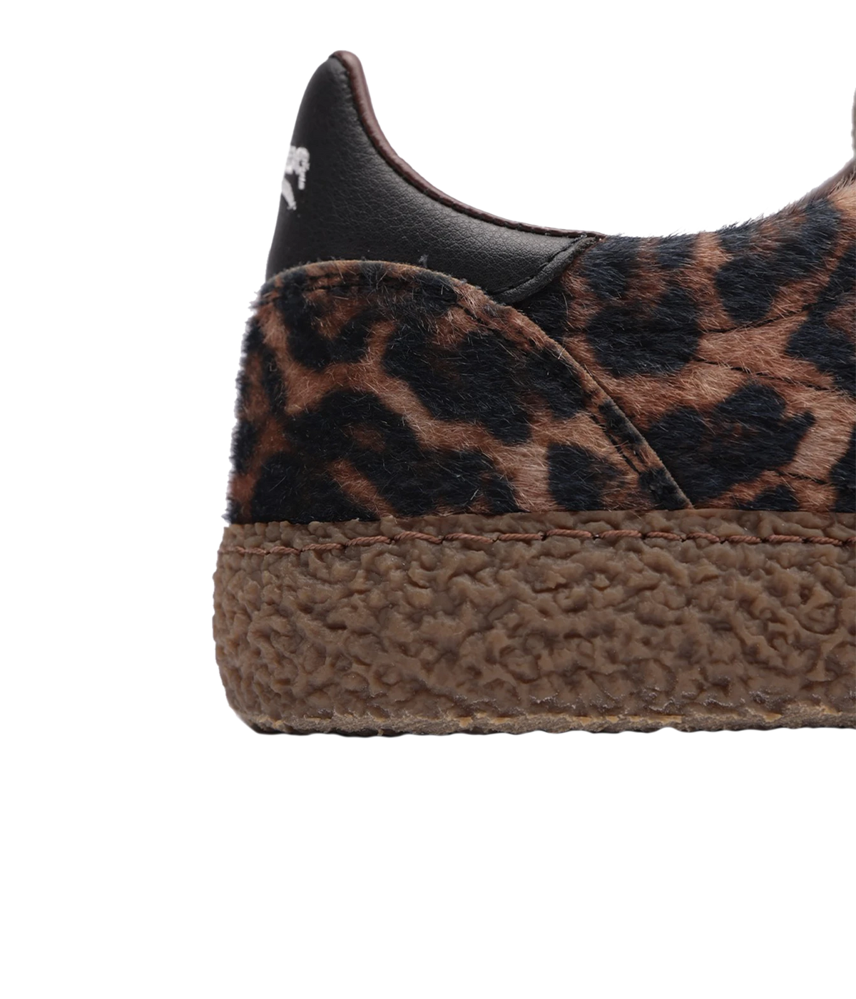 Close-up of a slip-on platform sneaker featuring a brown and black leopard print upper, black leather heel tab, and a thick brown braided espadrille-style sole on a white background.