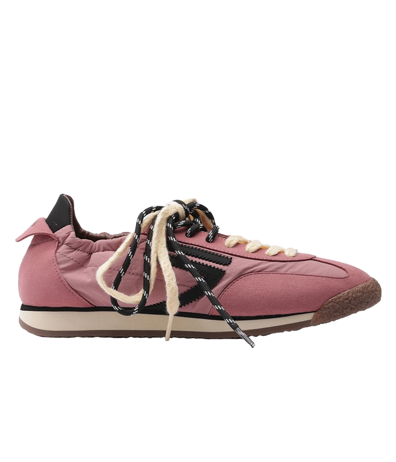 A pink low-top sneaker with black side stripes, cream laces, and a brown outsole, shown in profile against a white background.
