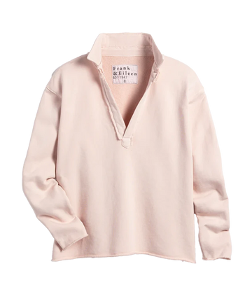 A light pink triple fleece sweatshirt with a raw hem and V neckline. Cropped without sacrificing coverage, you’ll love the sporty meets posh look of this bra friendly, wash and wear popover by Frank and Eileen. 