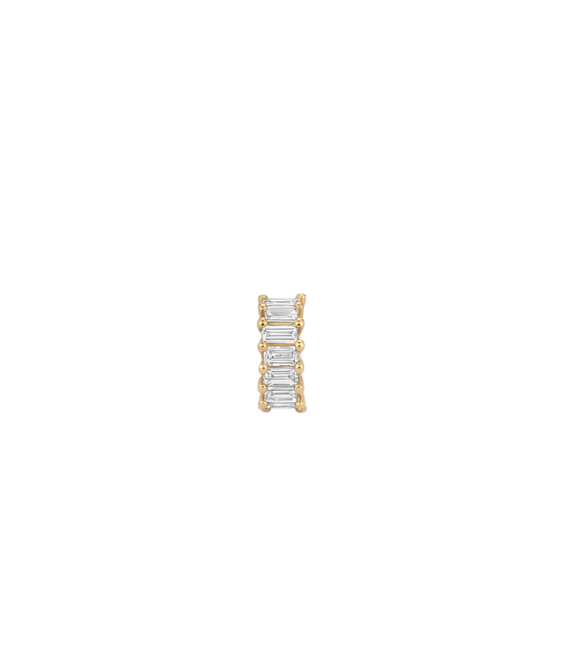 A gold band ring featuring a vertical channel setting of five baguette-cut clear stones, shown against a plain white background.